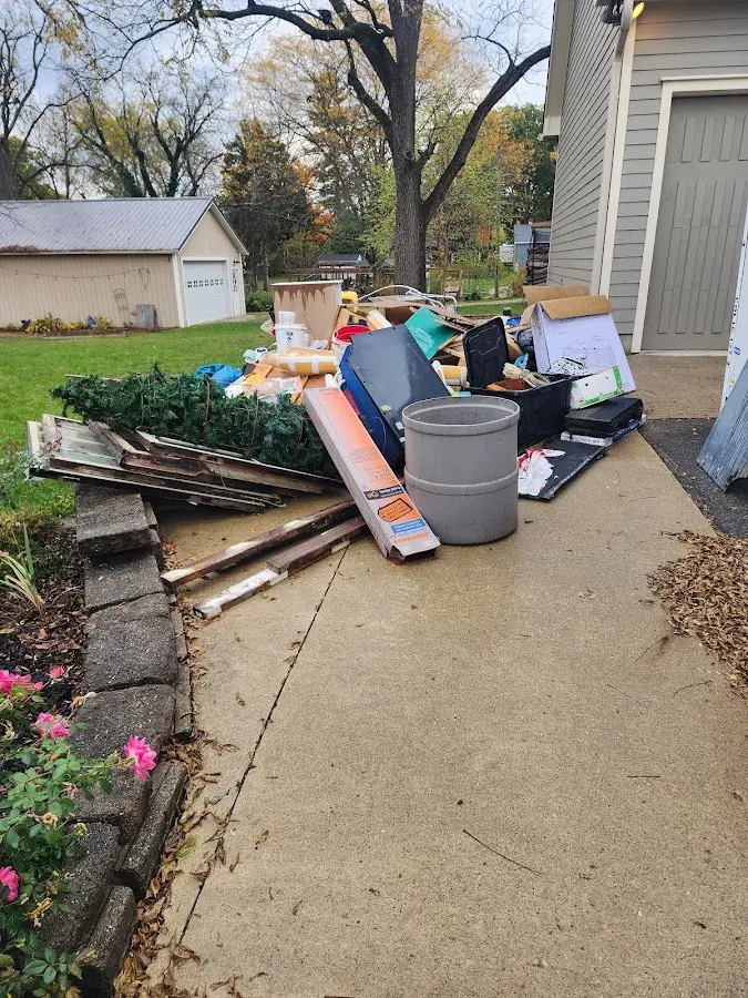 Dumpster being loaded with debris for Estate Cleanout Dumpster Rental in Mound